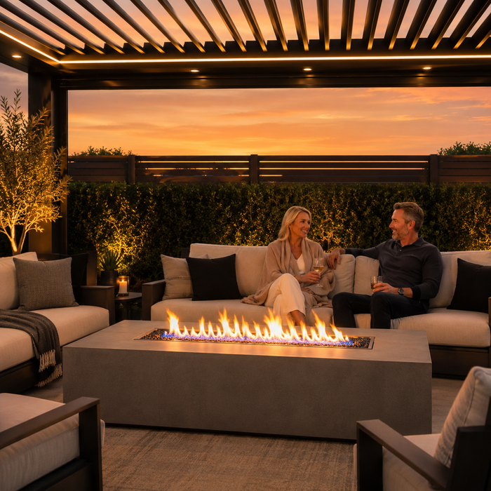 Gas fire pit table under a louvered pergola at dusk