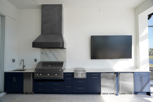 Full outdoor kitchen suite cabinets in Indigo with grill, side burner, and dual refrigerator columns