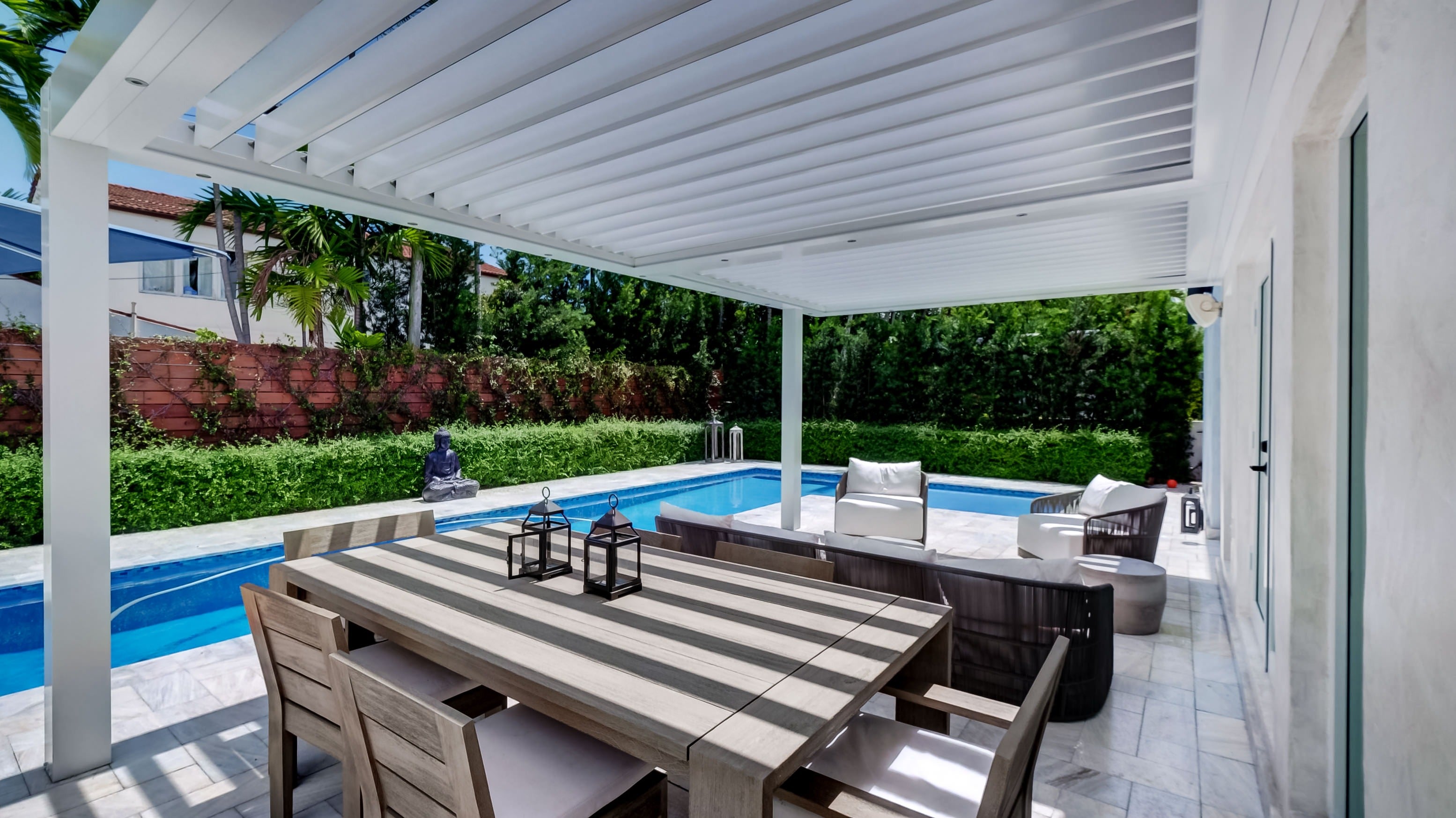 Sundance All Season louvered pergola as a poolside cabana in a premium backyard retreat