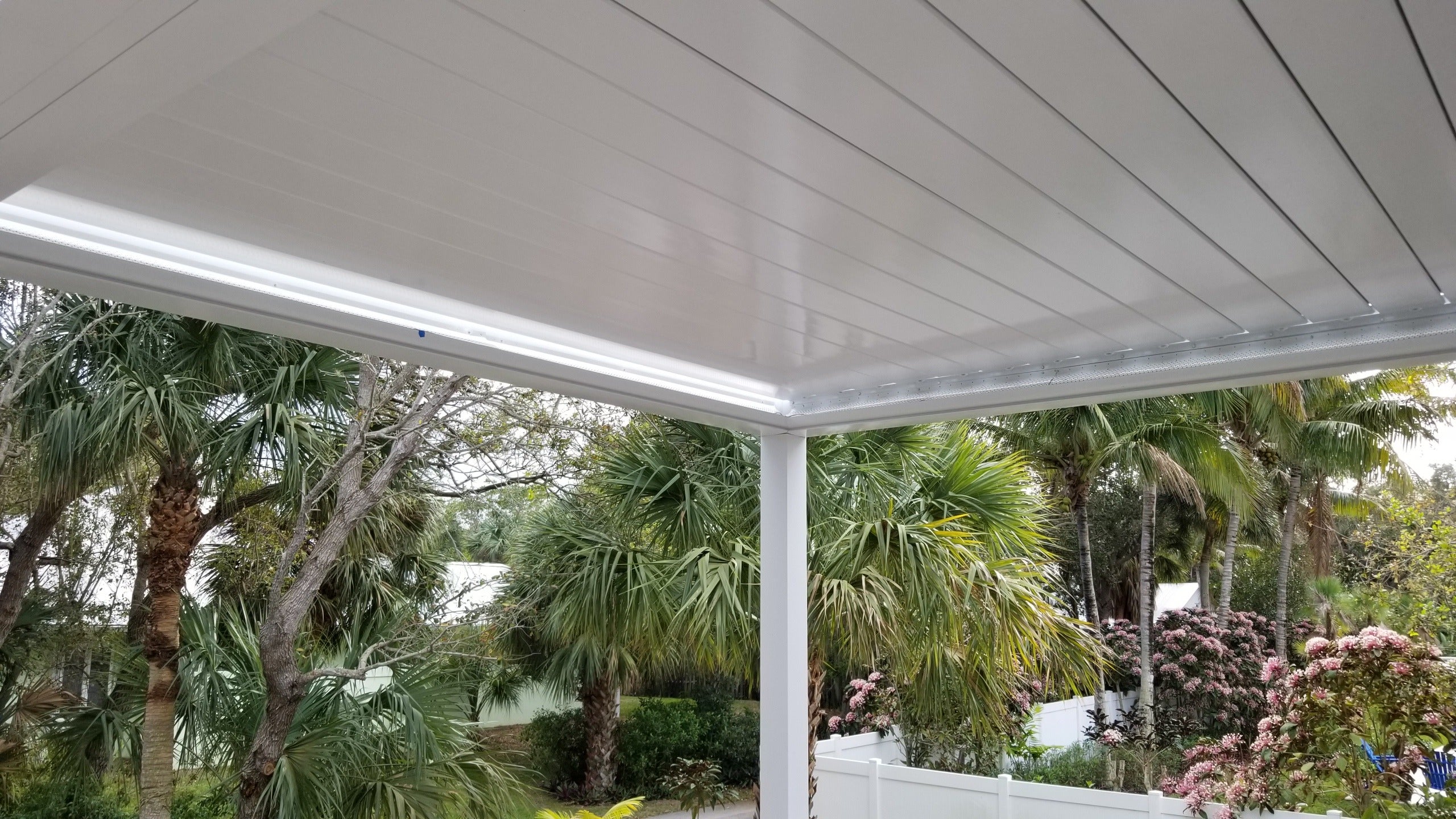 Close-up of a white Sundance louvered pergola roof with louvers closed showing aluminum build quality